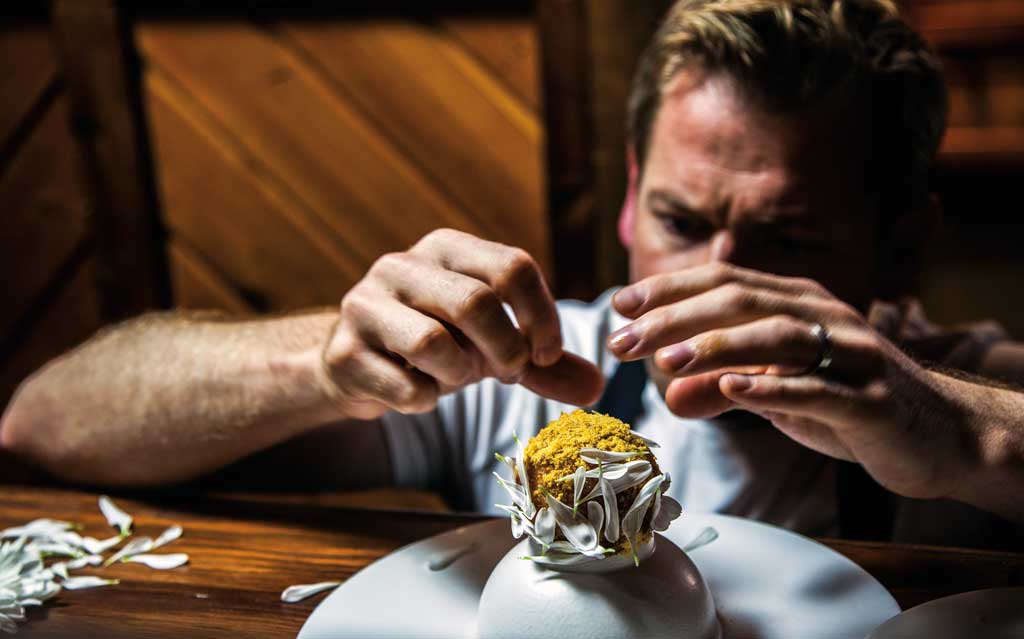 Chef Jan Hendrik crafting a delicate, gourmet dish, showcasing the artistry and precision of the best chefs in the world in 2025.