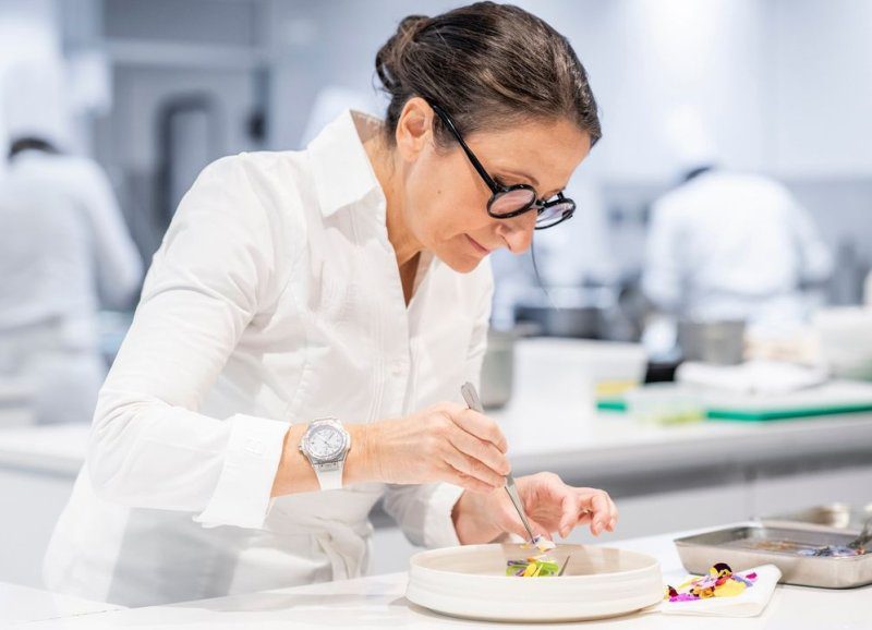 Anne Sophie Pic One of the best chefs in the world carefully plating a dish, showcasing Michelin-star creativity and precision.