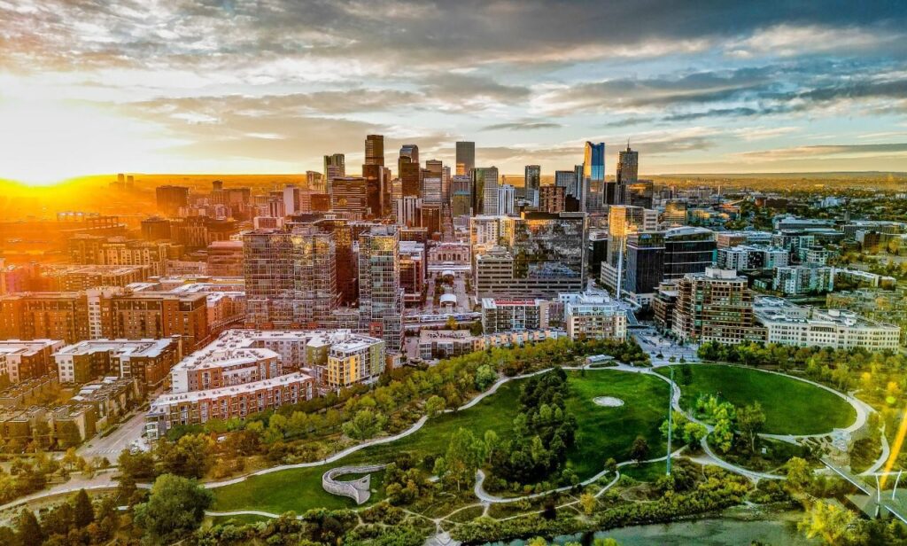 Aerial view of downtown Denver at sunset, showcasing the city skyline and urban parks—an inspiring destination for participants joining an intern program abroad or a trainee program abroad in the United States.